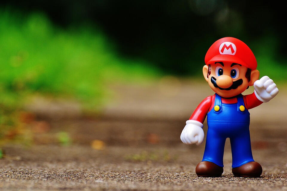 A colourful video game character toy standing outdoors